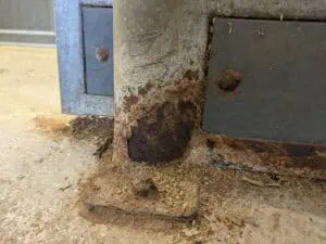 Galvanisk korrosion på metallstolpe i fuktig stallmiljö i häststall